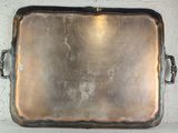 a metal tray with a handle on a shelf