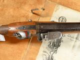 a gun that is sitting on top of a piece of paper