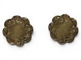 pair of antique brass buttons on a white background