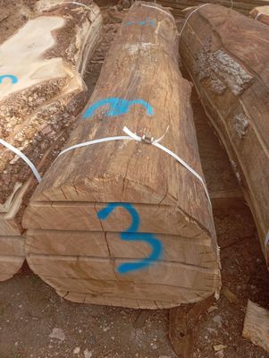 several large logs of wood are stacked on top of each other