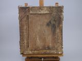 an old wooden easel with a painting on top of it