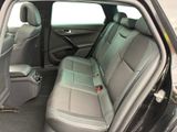 the back seats of a car with the door open and the driver ' s seat down