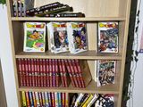 a book shelf with a lot of comic books on it