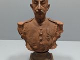 an old bust of a man with a mustache on top of a table