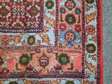 a close up of a rug on a carpet with a red border