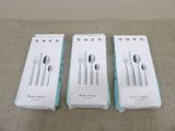 three boxes of silverware sitting on top of a table