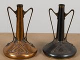 two vases sitting side by side on a table