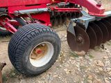 a red tractor that is parked on the side of the road