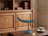 une table en bois sur laquelle est posé un oiseau bleu