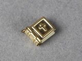 an image of a gold plated book charm with a cross on it