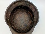 a brown bowl that is sitting on a white surface