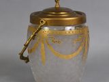 a glass jar with a gold lid on a gray surface
