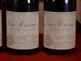 three bottles of wine sitting on a table next to each other