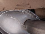 a metal pipe that is connected to a piece of cardboard