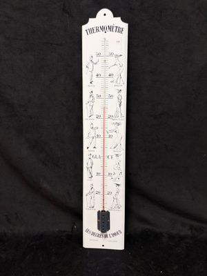 a white thermometer on a black background with a black background