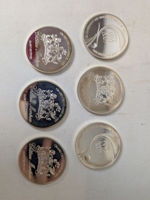 six different british coins on a white surface with a white background