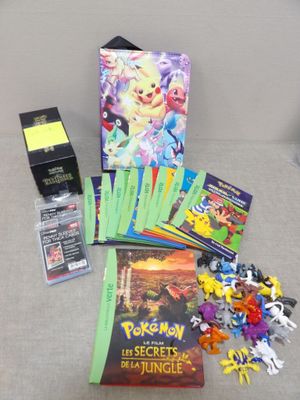 a lot of pokemon cards and a book on the couch
