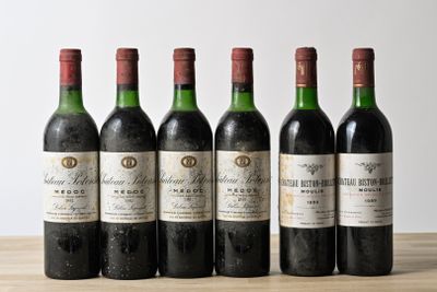 six bottles of wine are lined up on a wooden table