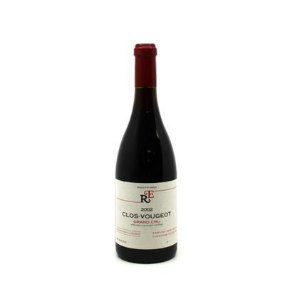 the bottle of red wine is sitting on a white surface