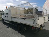 a white truck with a cage on the back of it