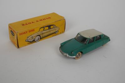 an old toy car and a box on a white surface