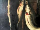 three fish hanging from the hooks on the wall