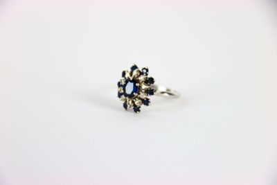 a close up of a ring on a table with a white background
