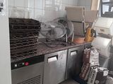 a small kitchen with a refrigerator and a lot of food on the counter