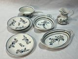 several pieces of blue and white dishes and a pitcher on a table