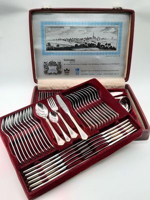 a red case with silverware in it on a white surface
