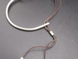 un bracelet blanc orné de deux perles argentées
