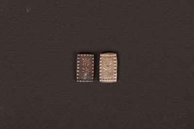 a close up of two pieces of metal on a black surface