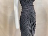 the mannequin is wearing a gray dress with a large ruched skirt