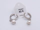 silver plated earrings with pearls and a tag on a white background
