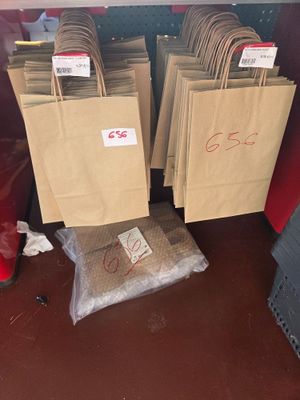 many bags of food sitting in the back of a truck