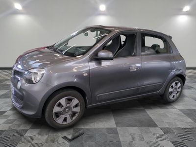 a small car that is parked on a checkered floor
