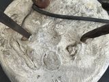 a metal object with a hammer on it on a table