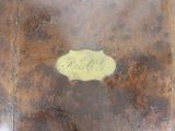 a piece of wood with a yellow label on it