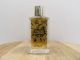 an image of a bottle of perfume sitting on top of a wooden table