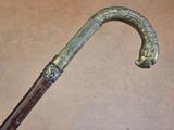 a close up of a cane with a handle on a table