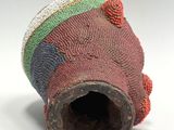 a close up of a colorful vase on a white surface