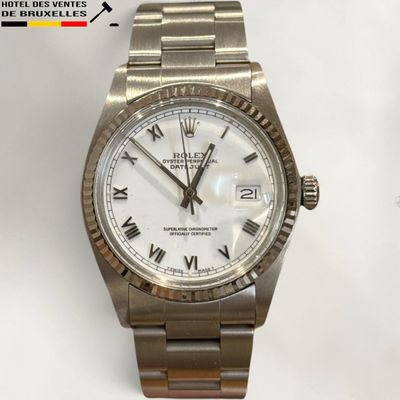 a close up of a wrist watch with roman numerals on it