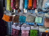 many bags of different colors and sizes of yarn on a rack