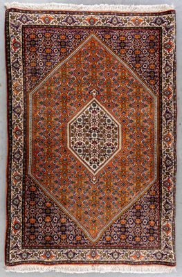 an antique persian rug with a geometric design