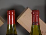 two bottles of wine sitting next to each other on a table