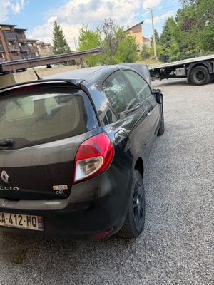 a black car parked in a parking lot next to a building