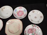 six plates with different designs on them sitting on a table