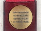 medal in a red box on a white surface with a red ribbon