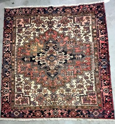 an old persian rug on the floor in a room