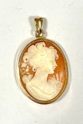 an image of a woman ' s profile is shown in a gold - plated pendant